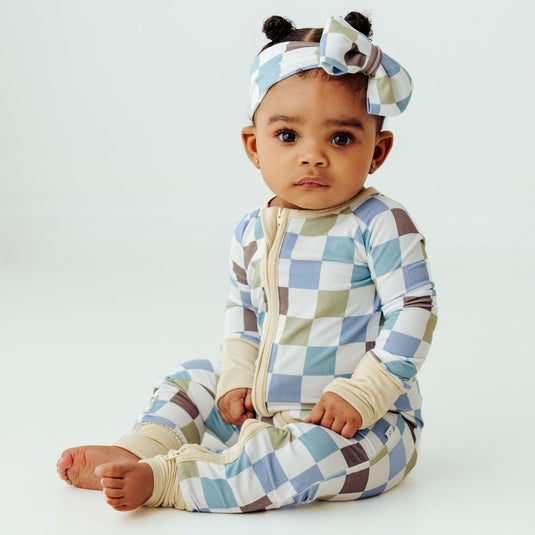 Baby wearing Luxe Checker bamboo sleeper, a stylish and breathable baby onesie perfect for everyday wear. A premium pick in bamboo baby clothes and elegant baby shower gifts.
