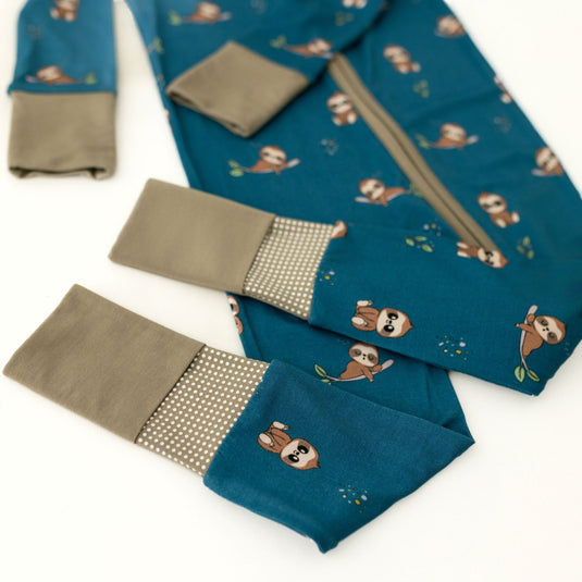 Teal bamboo sleeper with sloth patterns and brown accents on a white background