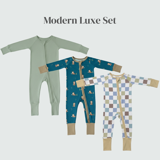 Three bamboo baby sleepers with different patterns on a light gray background, labeled 'Modern Luxe Set'.