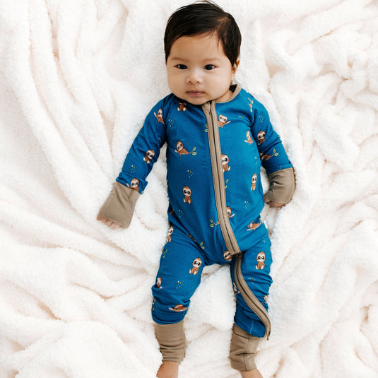 Sleepy Sloth | Baby in Sleepy Sloth bamboo baby sleeper – a cozy, hypoallergenic sleeper made for sensitive skin. A must-have in bamboo baby clothes and a thoughtful baby shower gift.
