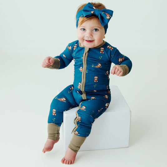 Baby wearing Sleepy Sloth bamboo baby sleeper – an ultra-soft sleeper designed for breathability and all-night comfort. A top choice in bamboo baby clothes and a perfect baby shower gift.