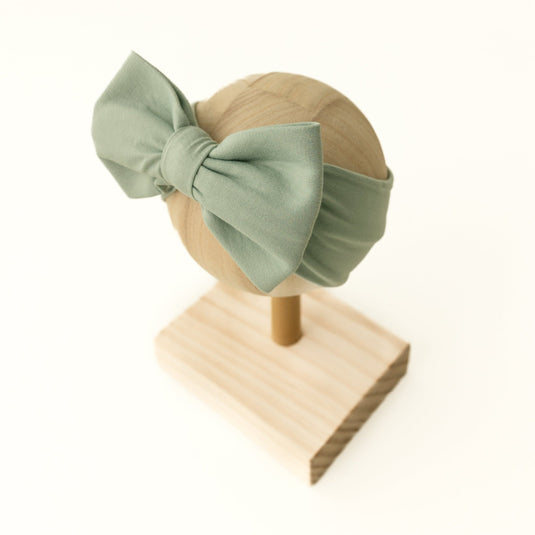 Frosted Sage bamboo bow headband – a soft and gentle hair accessory for newborns. Complements bamboo baby clothes beautifully and makes a thoughtful baby shower gift.