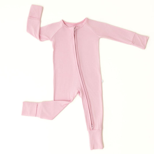 Flat lay of Petal Glow bamboo baby sleeper – showcasing the soft pink hue on ultra-soft bamboo baby clothes. These baby sleepers are a timeless and elegant baby shower gift.