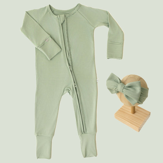 Baby Girl’s Essentials Bundle in Frosted Sage, featuring a breathable bamboo sleeper and one of our matching baby bows. A gender-neutral favorite in bamboo baby clothes and perfect for baby shower gifts.