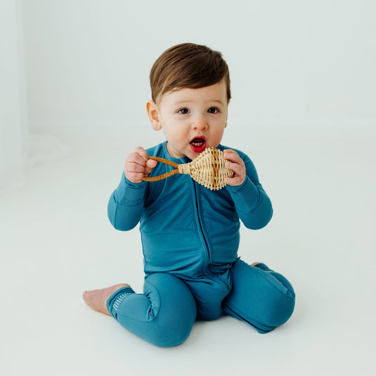 Baby wearing Blue Charcoal bamboo sleeper, a modern and cozy baby pajama made for comfort. A gender-neutral favorite in bamboo baby clothes and a perfect baby shower gift.
