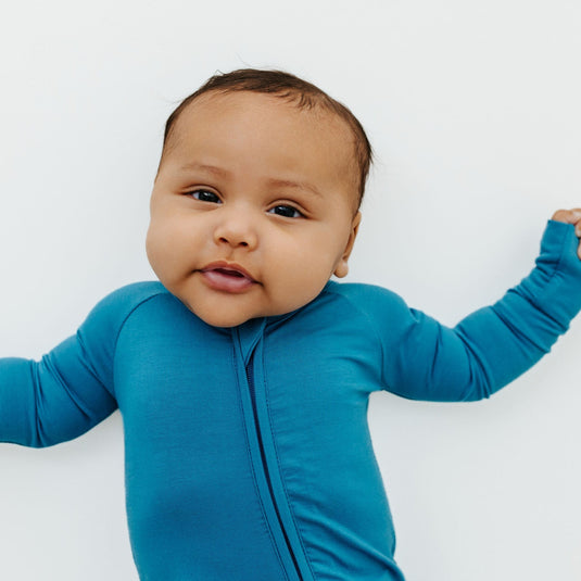 Featured in our Luxury Baby Shower Gift Set, this timeless Blue Charcoal bamboo sleeper is designed for softness, simplicity, and all-day comfort. A perfect gift for baby showers and new parents.