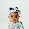 Baby in our Luxe Checker bamboo baby bows, a trendy accessory for newborns. The perfect complement to bamboo baby clothes and make chic baby shower gifts for new parents.