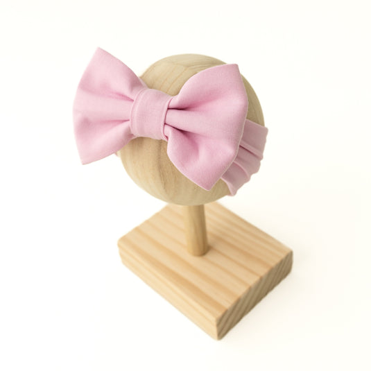 Petal Glow pink bamboo baby bows, ultra-soft comfort. A must-have accessory for baby girls that pairs perfectly with bamboo baby clothes and makes for sweet baby shower gifts.