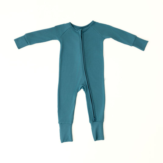 Flat lay of Blue Charcoal baby onesies, showcasing the rich blue color and premium texture of bamboo baby clothes. A sleek and timeless baby shower gift.