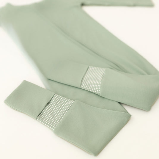 Close-up of Frosted Sage bamboo baby pajamas, showcasing the silky-smooth texture and breathable fabric. These baby onesies are a go-to choice in bamboo baby clothes and for baby shower gifts.