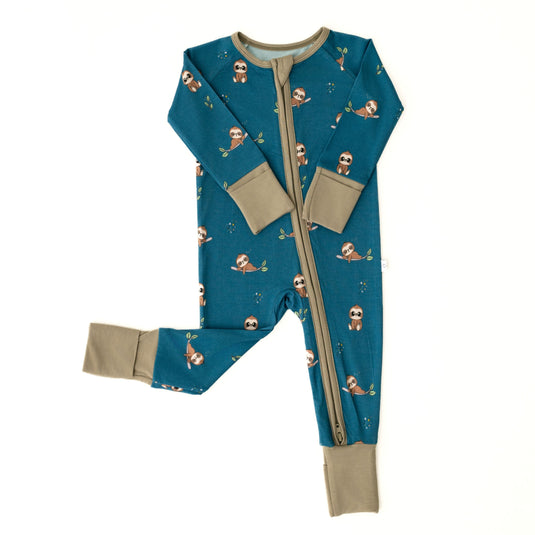 Flat lay of Sleepy Sloth bamboo baby pajamas, featuring a soft neutral design. These baby onesies are a timeless staple in bamboo baby clothes and gender-neutral baby shower gifts.