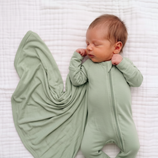 Frosted Sage | Newborn in matching Bamboo sleeper and stretchy swaddle blanket newborn essentials bundle