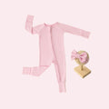 Baby Girl’s Essentials Bundle in Petal Glow, featuring an ultra-soft bamboo baby pajamas and one of our matching baby bows. A delicate and stylish pick in bamboo baby clothes and perfect for baby shower gifts.